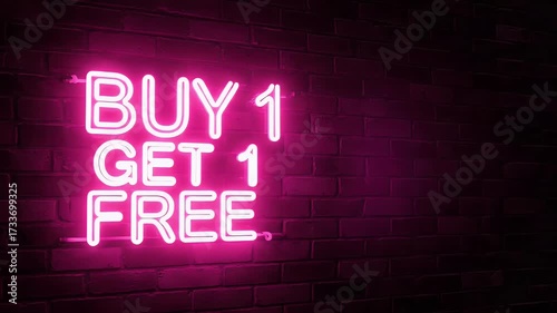 Eye-Catching Pink Neon 'Buy 1 Get 1 Free' Sign Illuminating a Dark Brick Wall, Symbolizing Retail Promotions and Special Offers