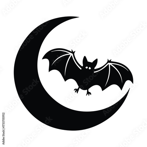 Silhouette of a bat flying across a crescent moon dark halloween night sky silhouette