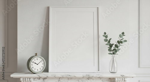 Blank white picture frame on marble mantel with decor