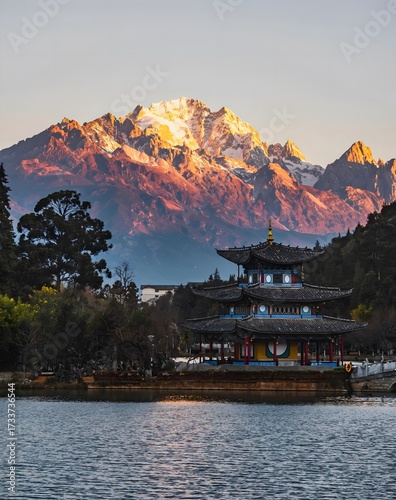 Traditional Chinese Pagoda at Black Dragon Pool with Jade Dragon Snow Mountain at Sunrise, Lijiang, Yunnan, China
