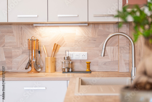 Modern natural wood kitchen interior with warm light