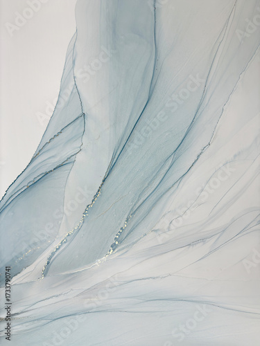 Abstract light blue aquarelle art background. Beautiful watercolor stains made with alcohol ink. Blue with beige and gold fluid art bird or angel wings, natural texture resembles sky, smoke, air.
