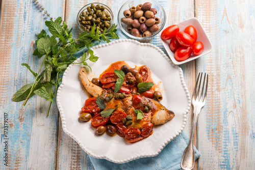 sword fish with olives capers and tomatoes