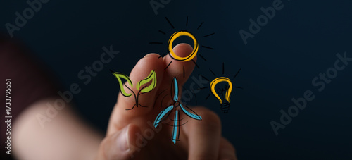 Human hand interacting with a digital interface displaying sustainable green energy concepts like solar, wind, and bioenergy for a cleaner futur