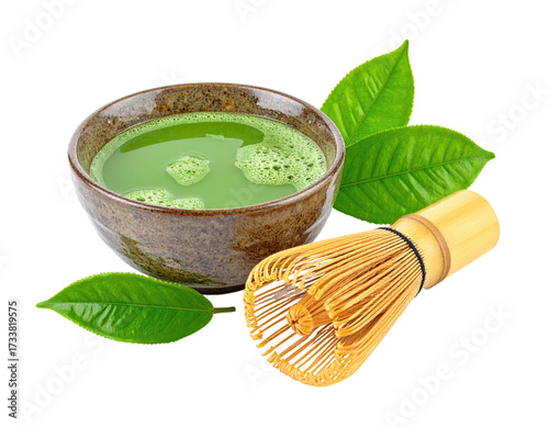 Vibrant green matcha tea in a brown bowl, with whisk and leaves, isolated on black