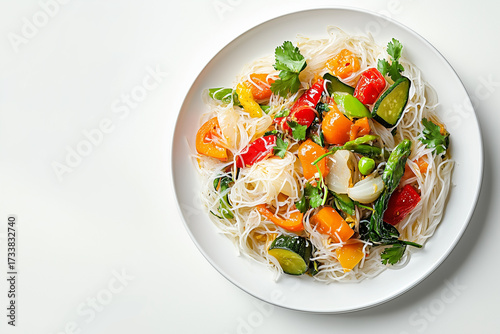 Vegetables and rice noodles on a white plate, top view