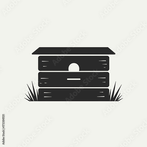 Black wooden beehive illustration with grass on a light background  