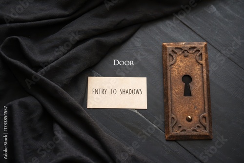 Rusted keyhole door plate with message on black fabric background