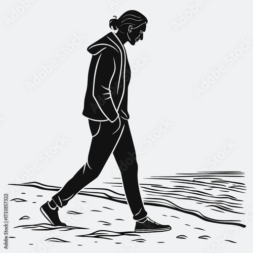 Black silhouette of a person walking on a beach sand