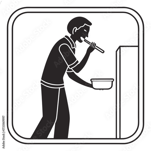 Person eating with spoon from bowl near cabinet food