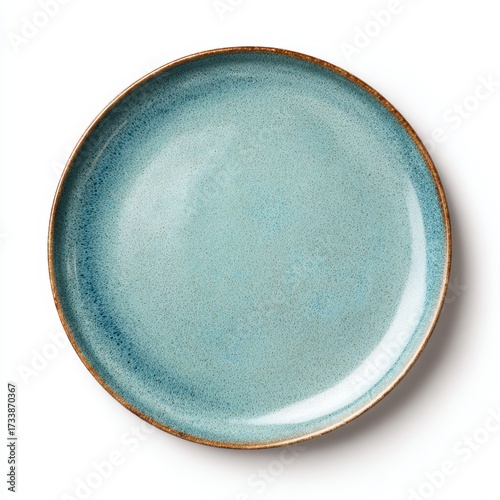 A top-down image of an empty, elegant ceramic plate with a blue-green hue and a dark brown edge. Its surface is glossy and refined.
