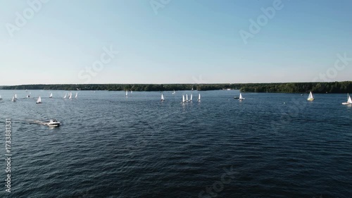 There are various boats and yachts sailing on the lake where people rest. Aerial photography on a summer day