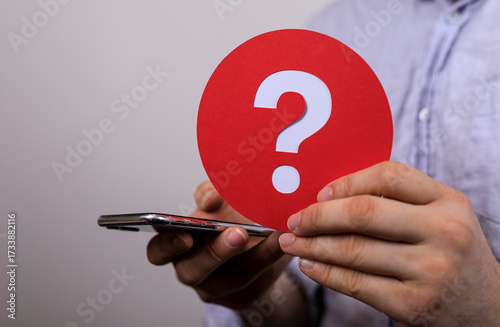 A man holds a red circle wi...