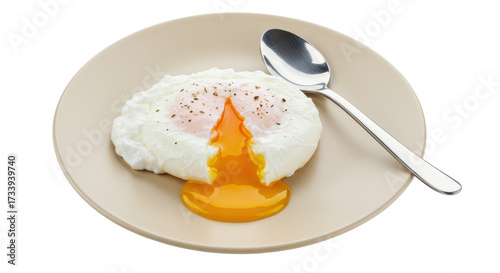 Perfectly poached egg with runny yolk isolated on beige plate, breakfast food photography