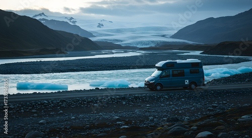 Scenic camper van adventure road trip by glacial river and mountain landscape