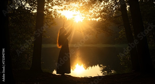 Silhouette of a person in nature with sunlight reflecting on water