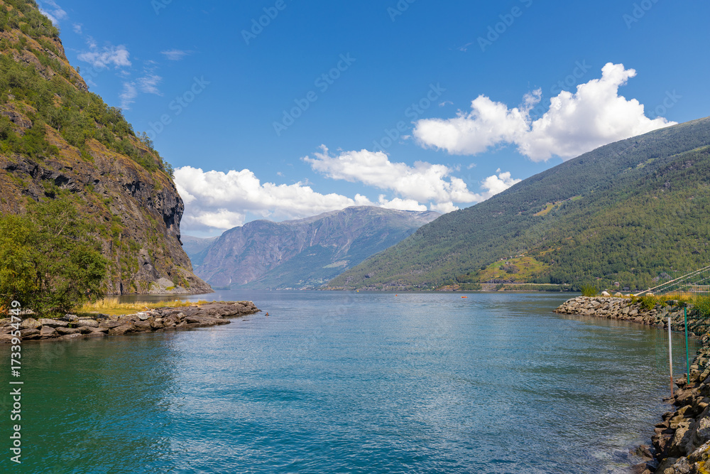 Fototapeta premium A beautiful Summer day in the UNESCO-listed Naeroyfjord in Norway, which is the most beautiful and wildest arm of the Sognefjord with at the end the picturesque village of Gudvangen, where you can sta