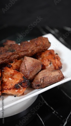 Delicious grilled meat skewers on a white plate ready to be served for dinner