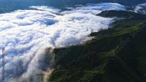 Wallpaper Mural Cinematic 4K aerial of dramatic clouds rolling over lush green mountain peaks. Perfect for nature films, travel promos, documentaries, and inspirational cinematic projects. Torontodigital.ca