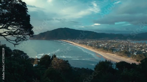 The view of a New Zealand town by the sea from the top of a mountain