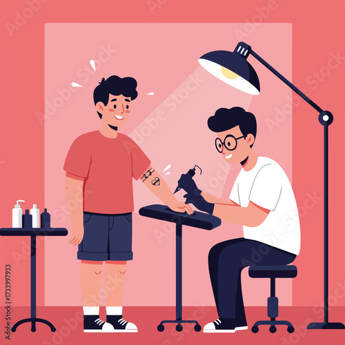 Young man getting a tattoo on his arm by an artist in a studio
