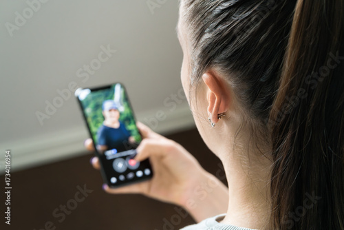 Date app scam and online romance fraud. Woman looking man's profile in phone screen. Single or couple. Cheating and infidelity. Catfish or mobile scammer. Swipe right or heart match.