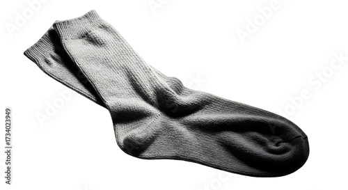 A single, wrinkled, grey sock lies on a white background, casting a subtle shadow.