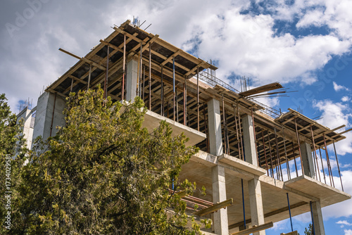 The frame of a building under construction. The structure of the building. Construction of load-bearing reinforced concrete columns at home. Construction technologies. Reinforcement of concrete.