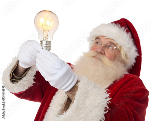 An elderly Caucasian man dressed as Santa Claus holds a glowing light bulb. He has a white beard, glasses, and wears a red suit with white fur trim.