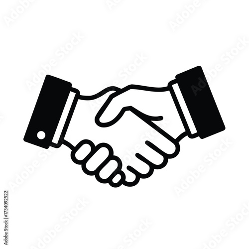 Close-up of two hands engaging in a firm handshake symbolizing agreement, cooperation, and mutual understanding in a professional setting