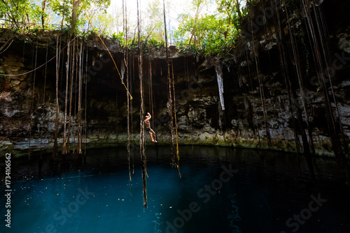 Tourist in Cenote Secreto Maya in Mexico