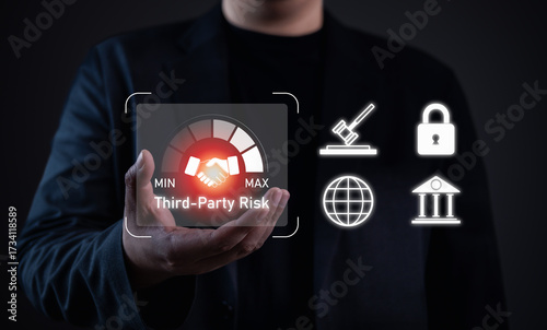 Third-party risk management concept. Businessman holding virtual gauge with handshake icon, highlighting partnership risk, compliance, cybersecurity, and regulatory challenges in business.