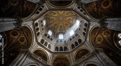 Inside a grand cathedral, looking up at a golden dome.  Sunlight streams through a high window