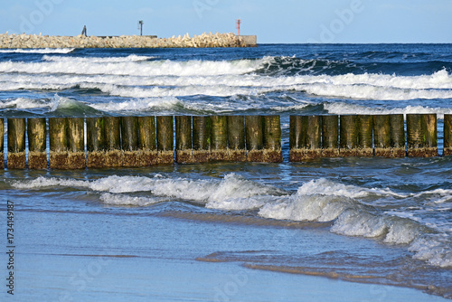 Ustka, Słupsk county, Pomorze, Pomerania, Poland, Euro : Ustka is popular holiday resort on South Coast of Baltic Sea, beach in September, wooden breakwater, in background concrete blocks breakwater