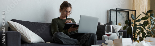 Wallpaper Mural Young woman struggles with sadness while sitting alone at home in a cozy environment Torontodigital.ca