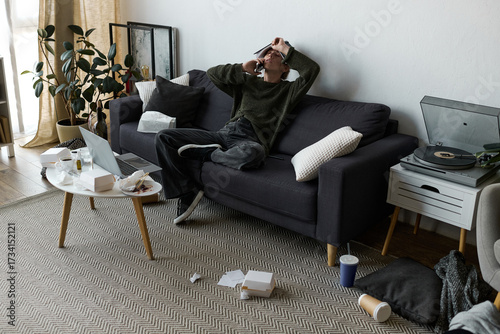 Photos Feeling overwhelmed while resting at home in a cluttered living room