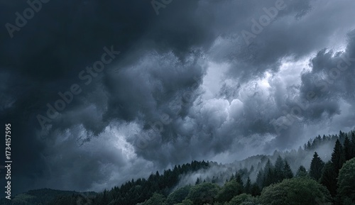 Dramatic storm clouds gather over a misty forest