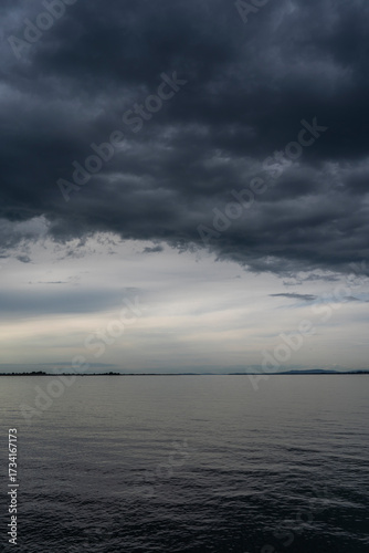 bad weather over Lake Constance / Bodensee in Bregenz Vorarlberg Austria with clouds and dramatic colours 