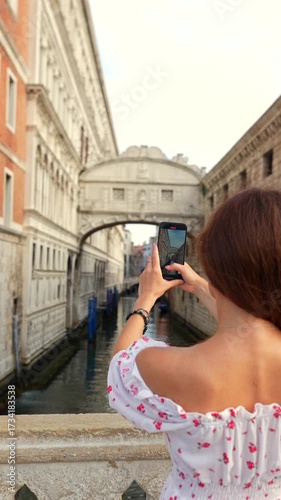 Tourist photographing Bridge of Sighs Venice in summer