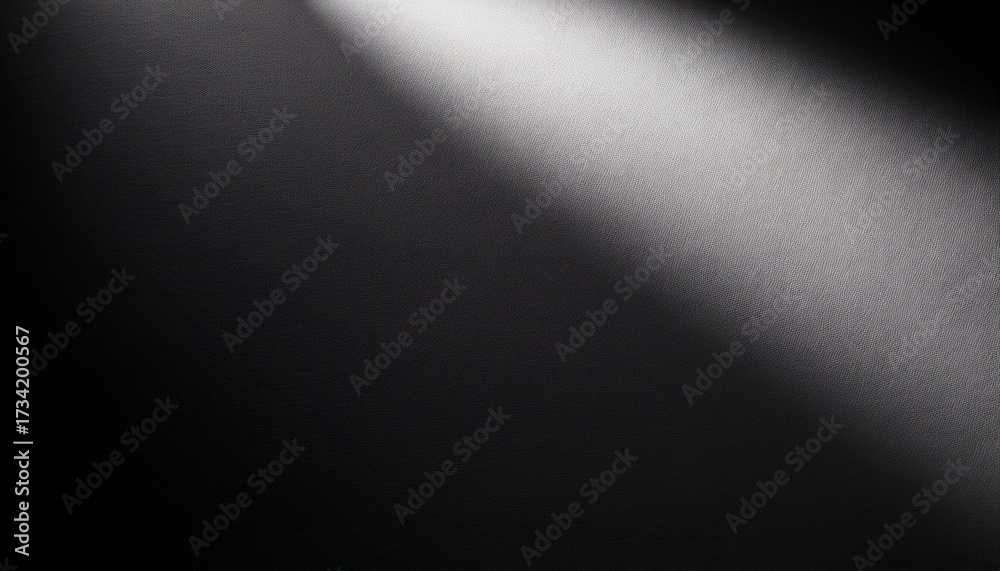 Obraz premium high contrast abstract gradient background with spotlight effect from upper left corner on dark surface dramatic black and light gray tones with deep shadows and bright highlights creating a moody a