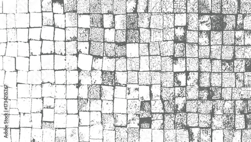 grey and white textured background of cracked stone pavement blocks arranged in a grid pattern.