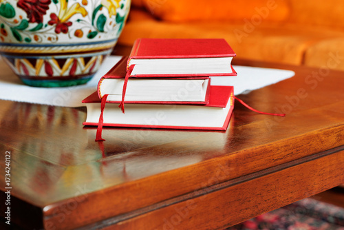 Hardbacked books on wooden table