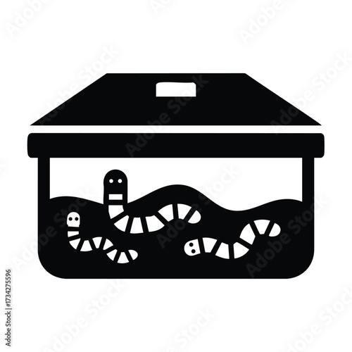 Pet terrarium with snakes and worms in a transparent container for reptile care and habitat display