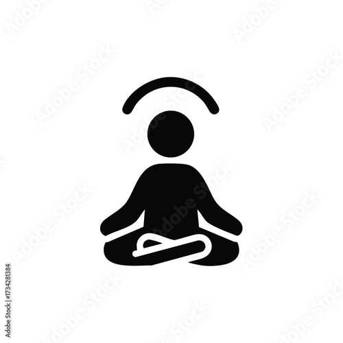 Person practicing meditation in a seated cross-legged position with hands resting on knees and a calm expression