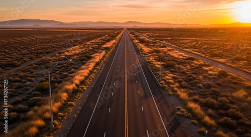 Endless highway stretches towards the horizon at sunset in the desert landscape