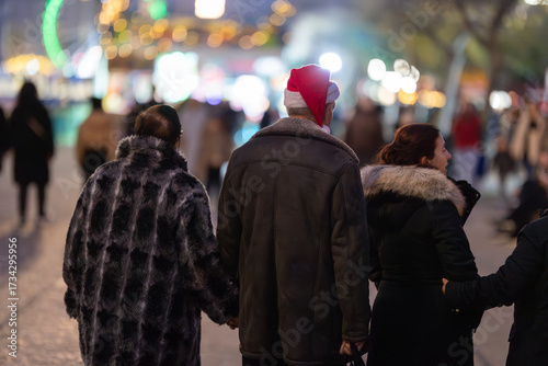 Group of people celebrating christmas at festive market