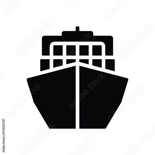 Front view of a large cargo ship sailing on open water with a clear sky in the