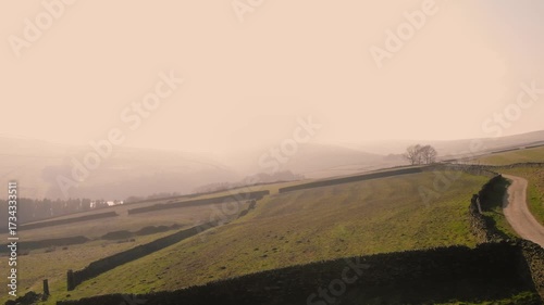 Countryside farmland in Peak District National Park on misty day landscape