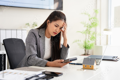 Asian investor businesswoman or rael estate agent getting stressed about real estate finance.