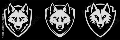 A fierce wolf or husky head inside a shield emblem. A powerful mascot for sports teams or security groups emphasizing protection and teamwork.
